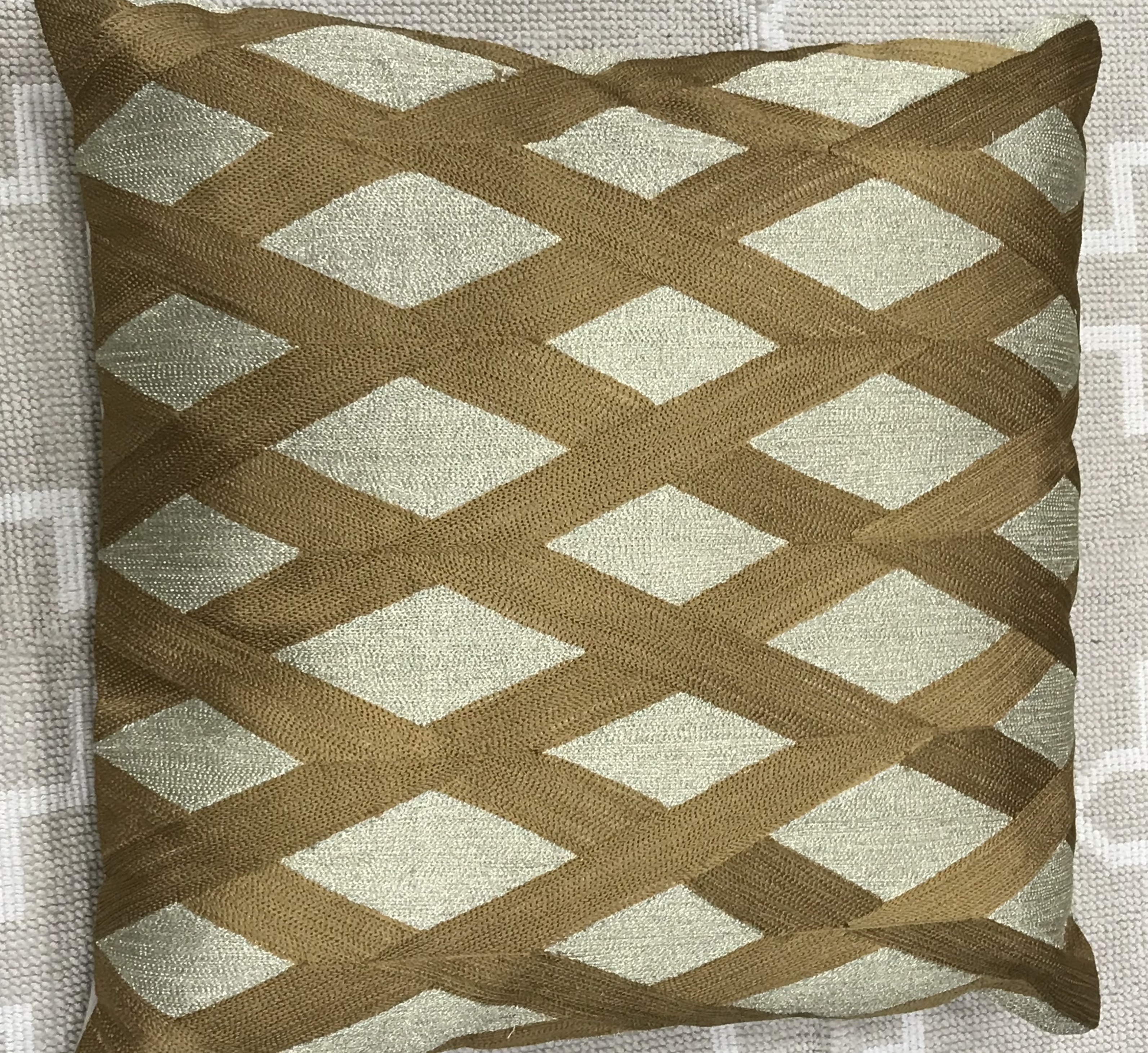 Embroidered light and bold gold cushion cover